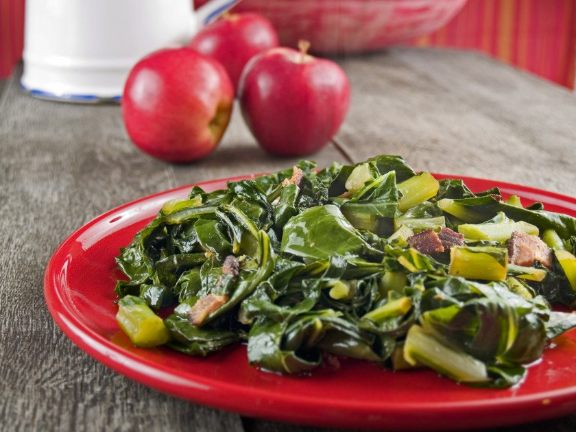 Culinary display of plate filled with bacon collard greens
