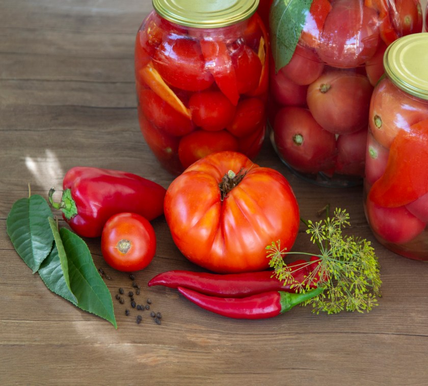  Preserves vegetables in glass on wood background, marinated ferm